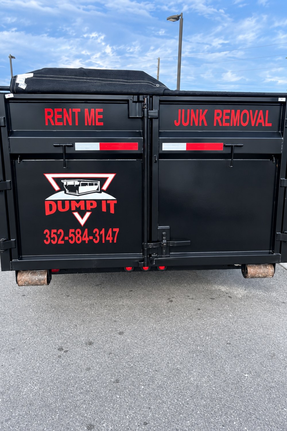 The branded rear doors of a Dump It container